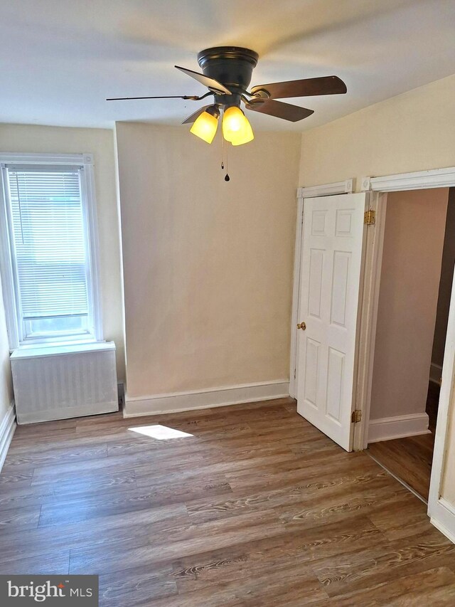 126 N Sickels St, Philadelphia, PA 19139 - unfurnished bedroom featuring wood finished floors, baseboards, and radiator