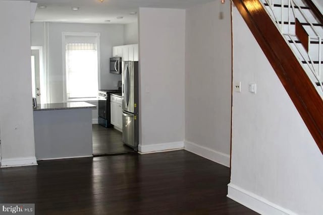 126 N Sickels St, Philadelphia, PA 19139 - kitchen featuring stainless steel appliances, white cabinetry, dark wood finished floors, baseboards, and dark countertops