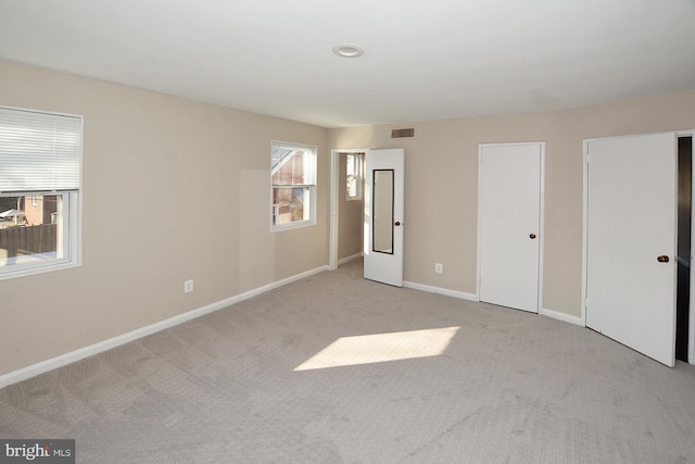 2626 12th St S Unit 1, Arlington, VA 22204 - unfurnished bedroom featuring multiple closets, light carpet, and baseboards