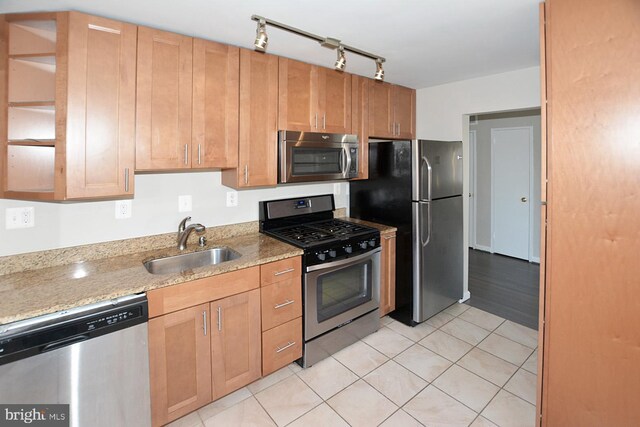 2626 12th St S Unit 1, Arlington, VA 22204 - kitchen with appliances with stainless steel finishes, a sink, light tile patterned floors, light stone countertops, and track lighting