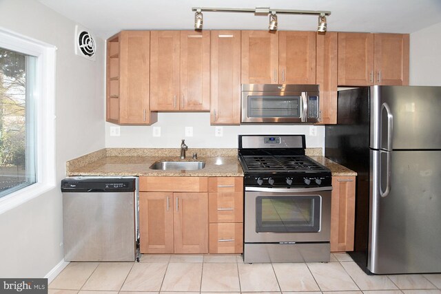 2626 12th St S Unit 1, Arlington, VA 22204 - kitchen with stainless steel appliances, a sink, light stone counters, and light tile patterned floors