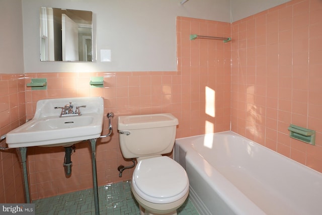 2626 12th St S Unit 1, Arlington, VA 22204 - bathroom featuring toilet, tile walls, a sink, and a wainscoted wall
