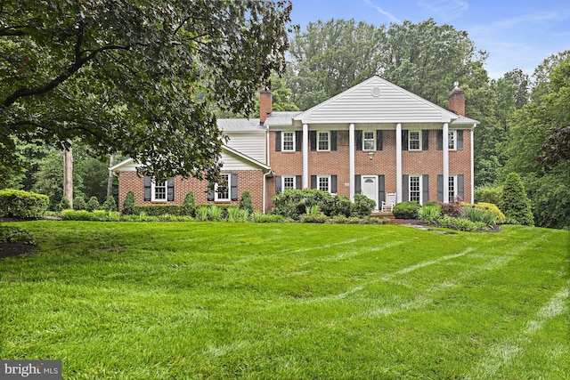 11904 Paradise Ln, Herndon, VA 20171 - neoclassical / greek revival house with a chimney, brick siding, and a front lawn