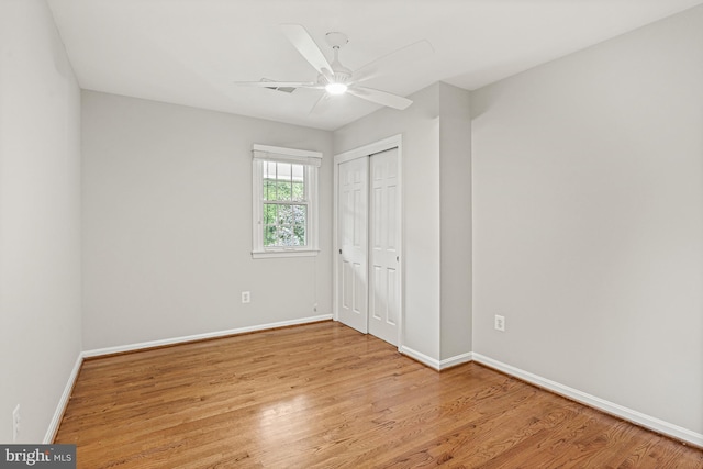 11904 Paradise Ln, Herndon, VA 20171 - unfurnished bedroom with baseboards, wood finished floors, a closet, and ceiling fan