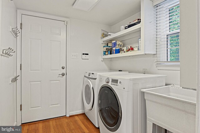 11904 Paradise Ln, Herndon, VA 20171 - washroom with washer and clothes dryer, light wood-style floors, and baseboards