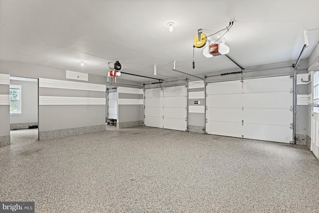 11904 Paradise Ln, Herndon, VA 20171 - garage featuring a garage door opener and baseboards