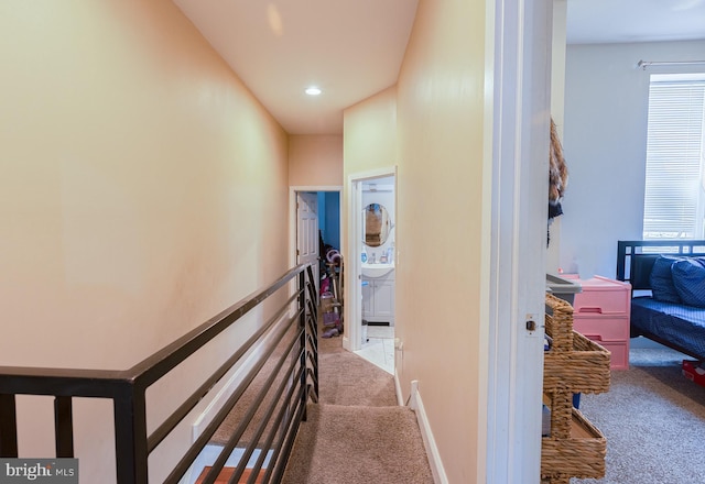 2218 N Woodstock St, Philadelphia, PA 19132 - corridor with light colored carpet, an upstairs landing, and recessed lighting