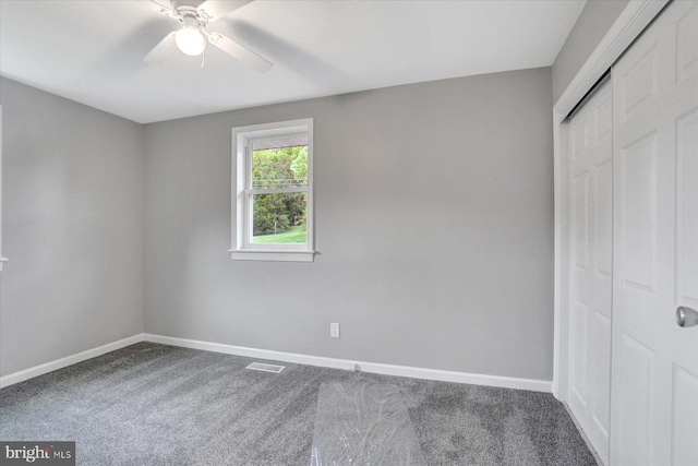 unfurnished bedroom with baseboards, carpet floors, a closet, and ceiling fan
