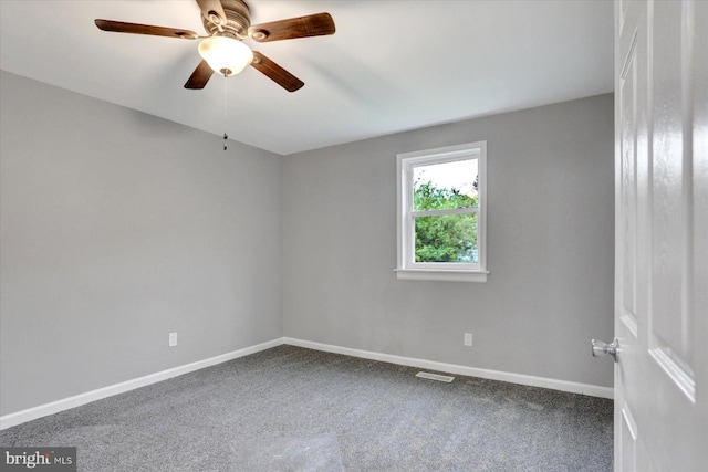 spare room with baseboards, carpet, and a ceiling fan
