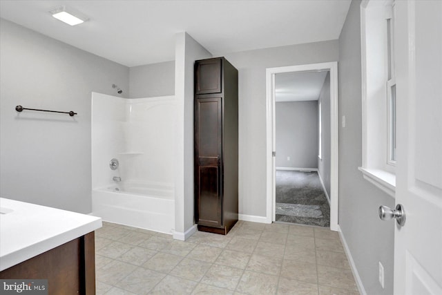 full bathroom featuring tub / shower combination, vanity, and baseboards