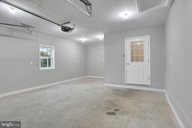 garage featuring a garage door opener and baseboards