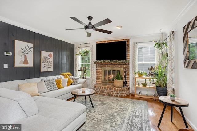 1015 E Macphail, Bel Air, MD 21015 - living room with crown molding, wood finished floors, ceiling fan, a brick fireplace, and wooden walls