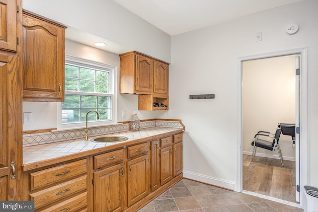 1015 E Macphail, Bel Air, MD 21015 - kitchen featuring a sink, tile countertops, baseboards, and brown cabinets