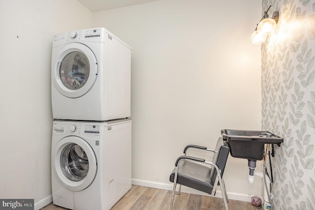 1015 E Macphail, Bel Air, MD 21015 - washroom with stacked washer and clothes dryer, light wood-style flooring, and baseboards