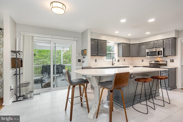 1015 E Macphail, Bel Air, MD 21015 - kitchen with stainless steel microwave, gray cabinetry, backsplash, light countertops, and recessed lighting