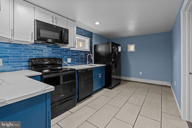 kitchen with black appliances, baseboard heating, decorative backsplash, white cabinetry, and a sink