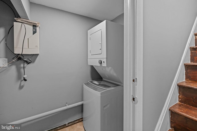 clothes washing area featuring estacked washer and dryer