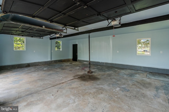 garage featuring a garage door opener and baseboards