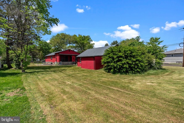 view of yard with an outbuilding and a pole building