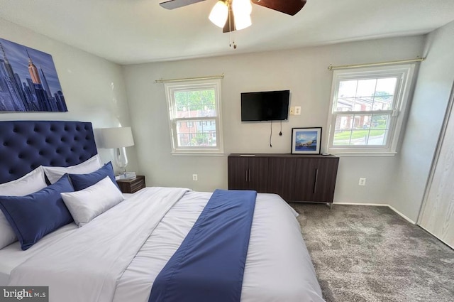 carpeted bedroom with baseboards and a ceiling fan