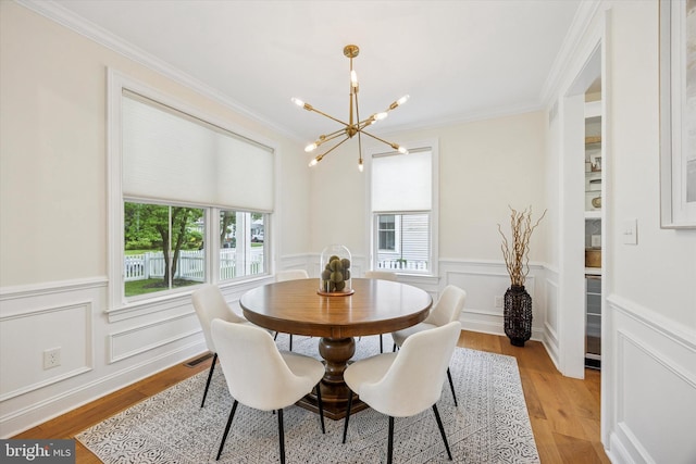17 W Redman Ave, Haddonfield, NJ 08033 - dining area featuring a chandelier, plenty of natural light, crown molding, light wood-type flooring, and wainscoting