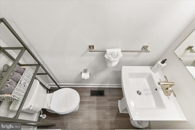 6034 Goshawk St, New Market, MD 21774 - bathroom featuring wood finished floors, baseboards, a sink, and toilet