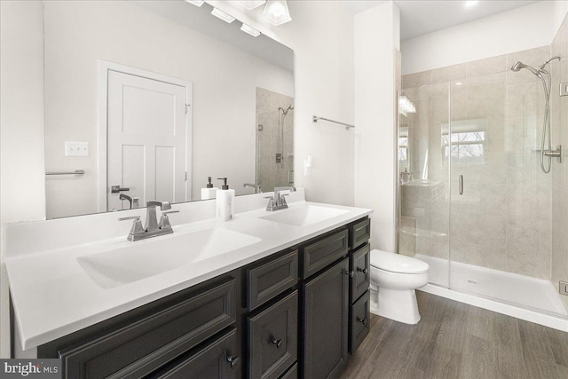6034 Goshawk St, New Market, MD 21774 - full bath featuring wood finished floors, a stall shower, toilet, and double vanity