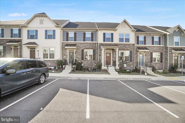 6034 Goshawk St, New Market, MD 21774 - view of front of house featuring uncovered parking, stone siding, and board and batten siding