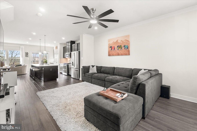 6034 Goshawk St, New Market, MD 21774 - living room with dark wood-style floors, a ceiling fan, recessed lighting, baseboards, and ornamental molding