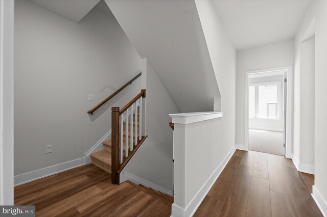 stairs featuring wood finished floors and baseboards