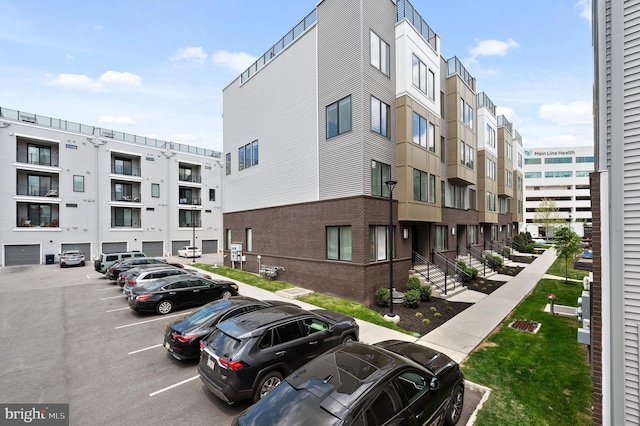 view of building exterior featuring uncovered parking