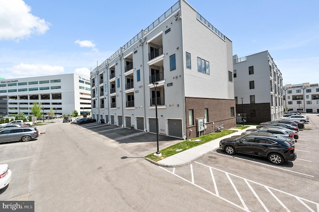 view of apartment building / complex featuring uncovered parking