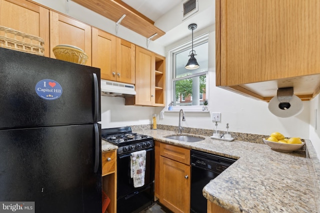 1215 Walter St SE, Washington, DC 20003 - kitchen featuring black appliances, under cabinet range hood, a sink, hanging light fixtures, and light stone countertops