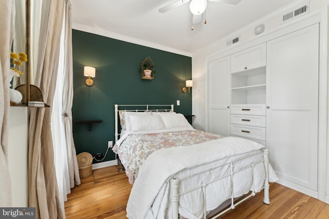 1215 Walter St SE, Washington, DC 20003 - bedroom with light wood-type flooring, crown molding, a ceiling fan, baseboards, and a closet