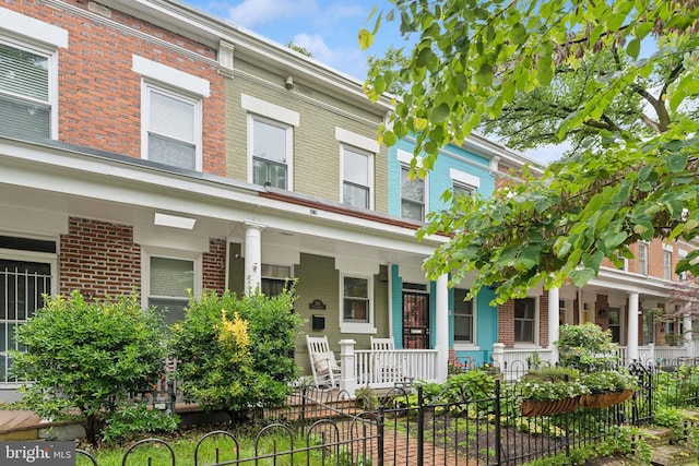1215 Walter St SE, Washington, DC 20003 - multi unit property with a porch, brick siding, and a fenced front yard
