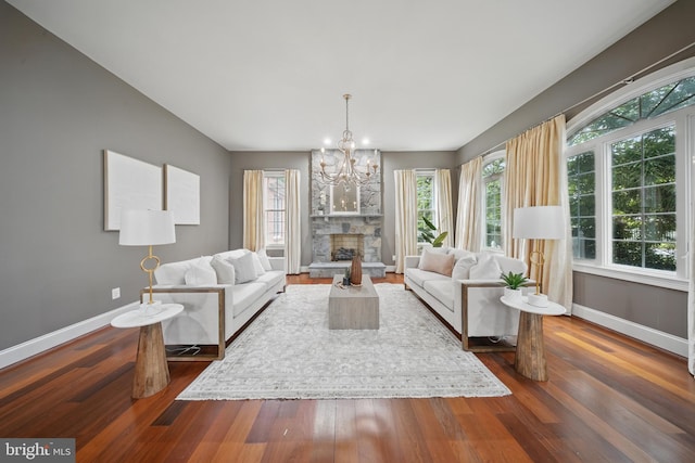 43582 Old Kinderhook Dr, Ashburn, VA 20147 - living room with baseboards, a chandelier, dark wood finished floors, and a fireplace