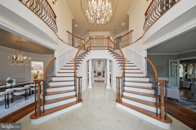 43582 Old Kinderhook Dr, Ashburn, VA 20147 - foyer featuring a high ceiling, a chandelier, stairs, and ornamental molding