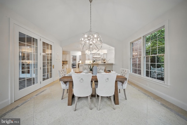 43582 Old Kinderhook Dr, Ashburn, VA 20147 - dining space featuring a chandelier, baseboards, lofted ceiling, and inlaid floor details