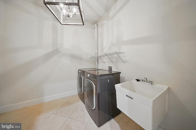 43582 Old Kinderhook Dr, Ashburn, VA 20147 - washroom featuring separate washer and dryer, baseboards, light tile patterned flooring, and a chandelier