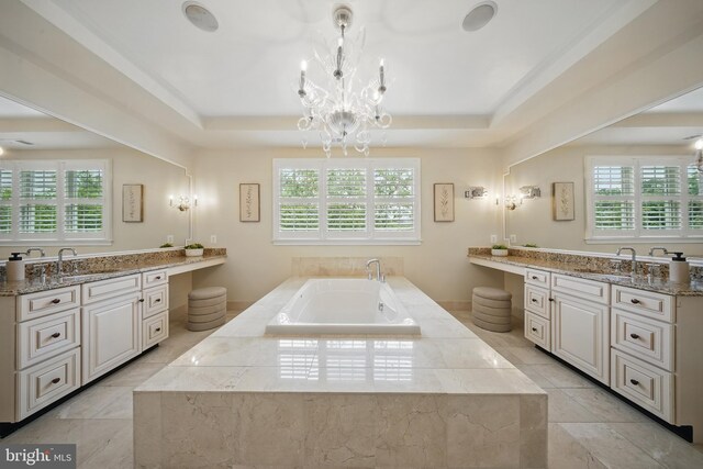 43582 Old Kinderhook Dr, Ashburn, VA 20147 - full bathroom with a chandelier, vanity, a garden tub, and a tray ceiling