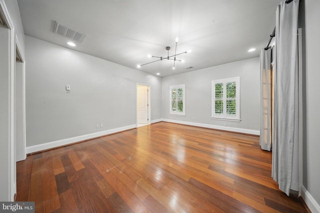 43582 Old Kinderhook Dr, Ashburn, VA 20147 - unfurnished room with a chandelier, wood-type flooring, baseboards, and recessed lighting