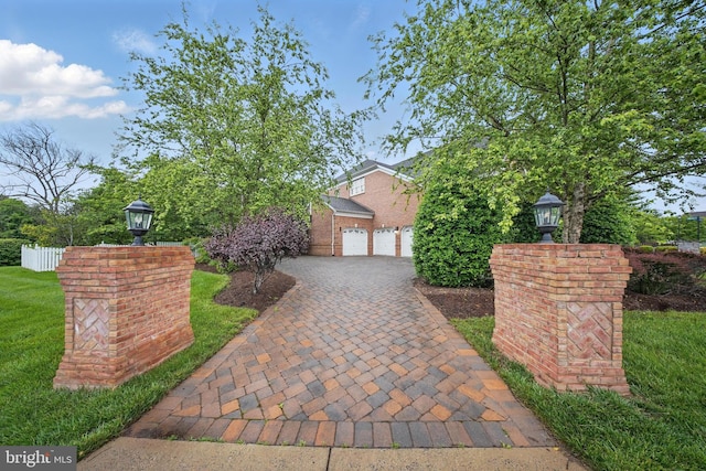 43582 Old Kinderhook Dr, Ashburn, VA 20147 - obstructed view of property featuring a garage, driveway, and brick siding