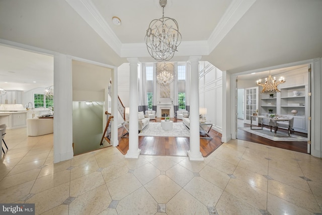 43582 Old Kinderhook Dr, Ashburn, VA 20147 - foyer entrance featuring a chandelier, decorative columns, plenty of natural light, ornamental molding, and a high ceiling