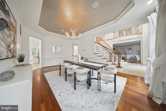 43582 Old Kinderhook Dr, Ashburn, VA 20147 - dining room with a raised ceiling, stairs, a chandelier, wood-type flooring, and crown molding
