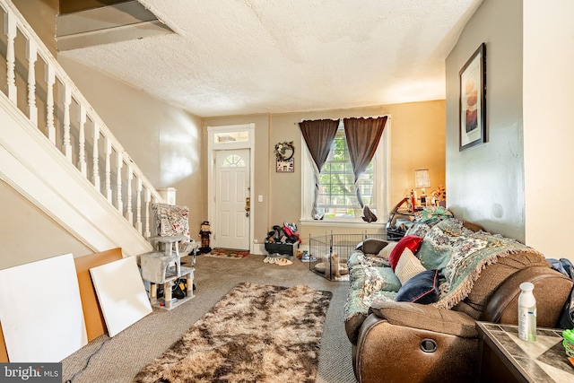 722 E 22nd St, Wilmington, DE 19802 - carpeted living room featuring a textured ceiling and stairway