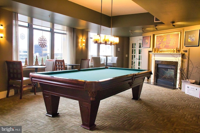 recreation room featuring carpet flooring, pool table, a fireplace, and a chandelier