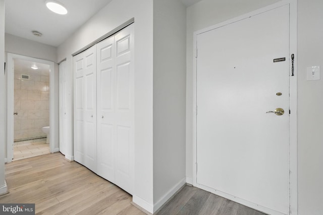 foyer entrance featuring light wood-style flooring