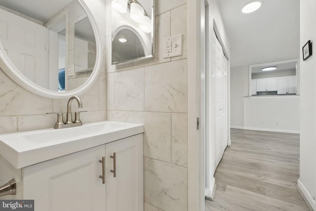 bathroom featuring wood finished floors, vanity, and baseboards