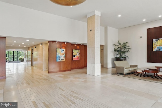 building lobby featuring a high ceiling and recessed lighting