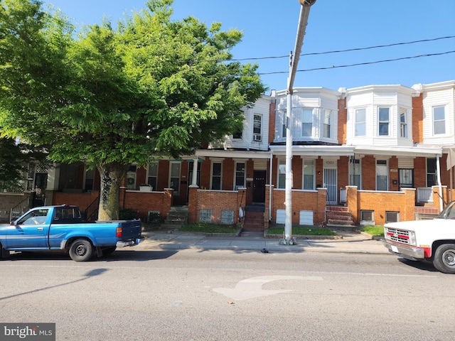 multi unit property with brick siding and covered porch